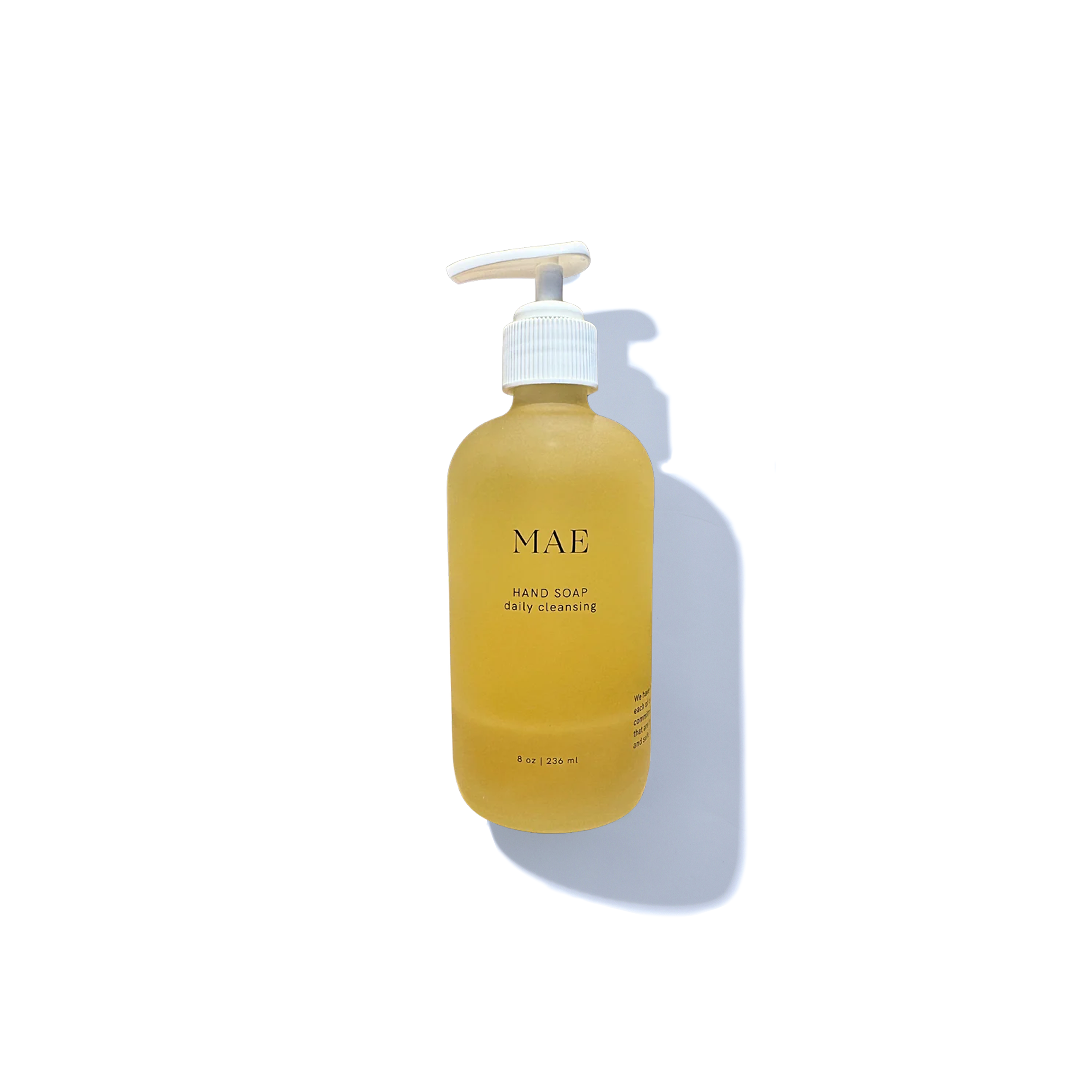 Yellow bottle of MAE hand soap on a white background