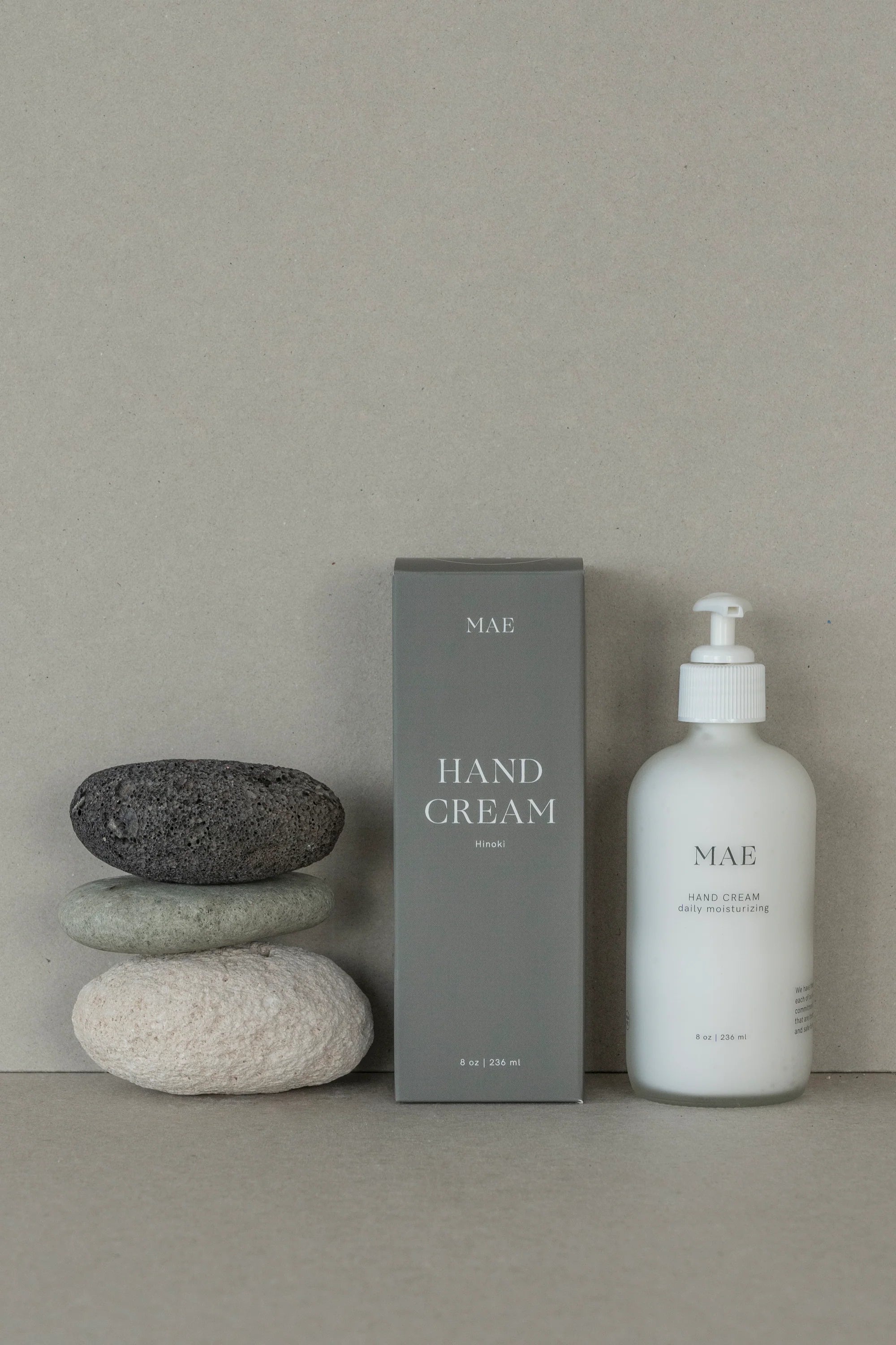 Hand cream packaging with pump and box on a neutral background