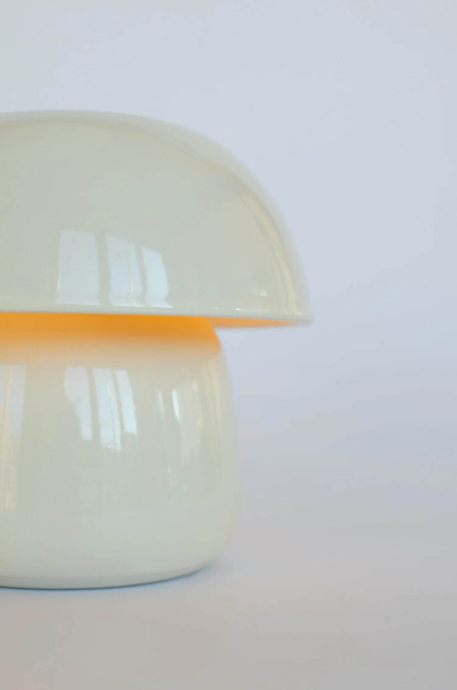 White ceramic mushroom-shaped object on a white background