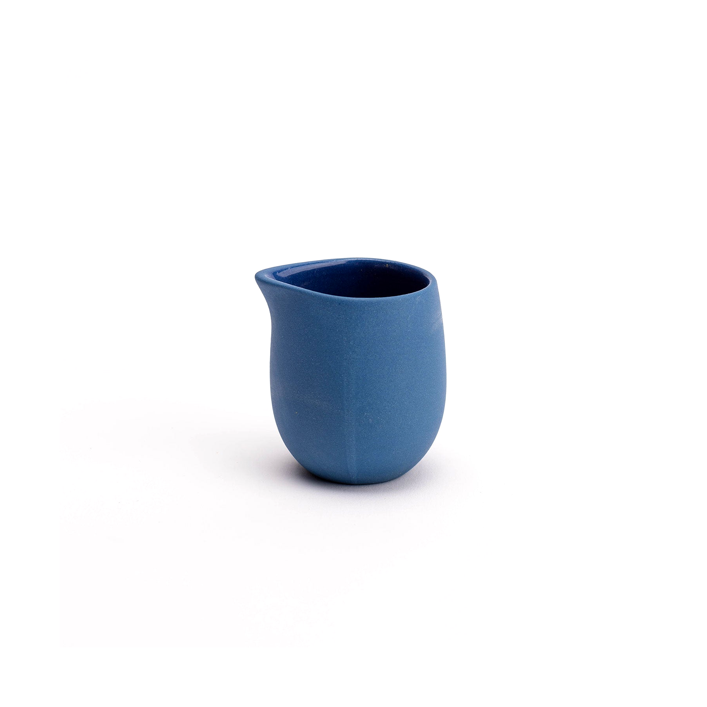 Blue ceramic pitcher on a white background