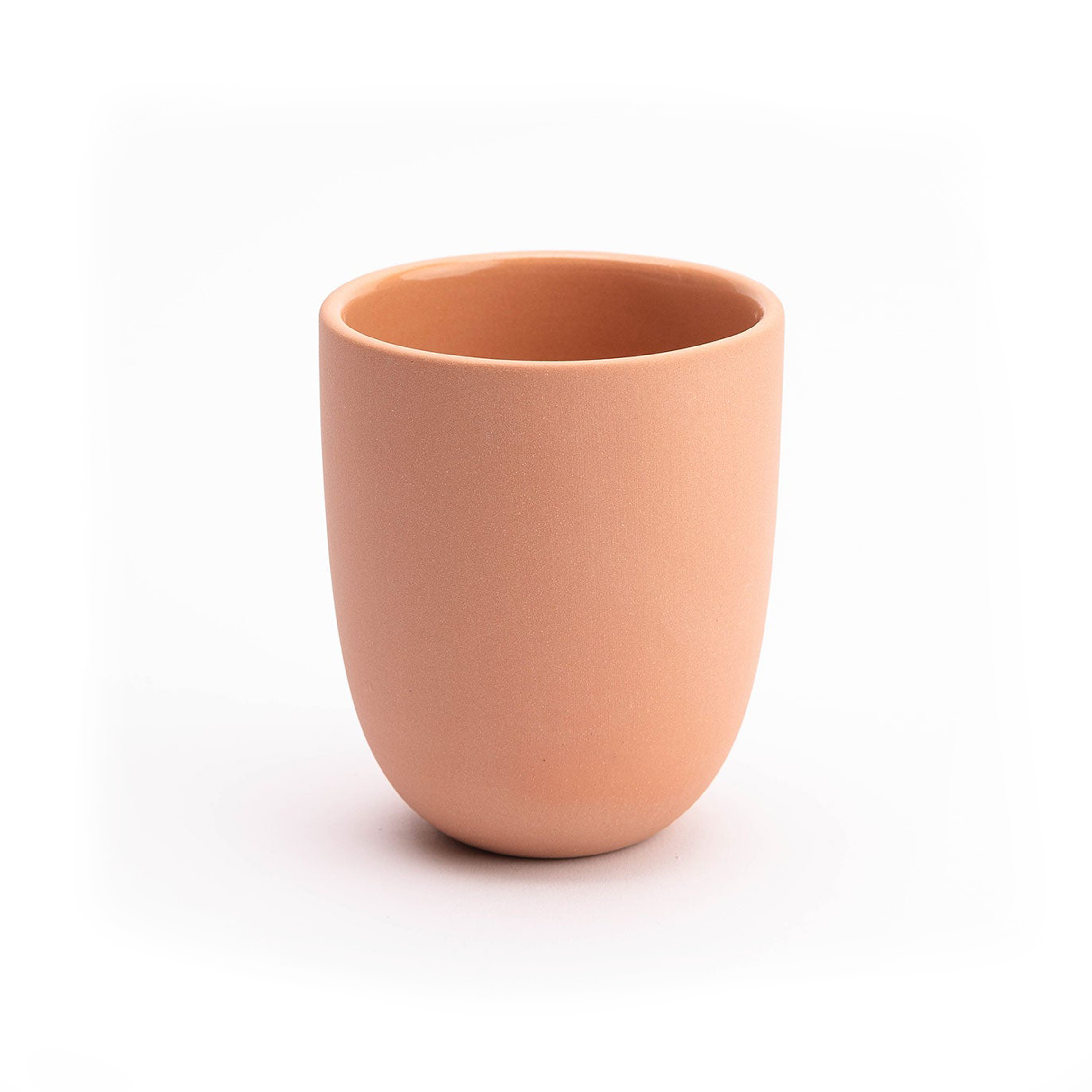 Terracotta-colored ceramic cup on a white background